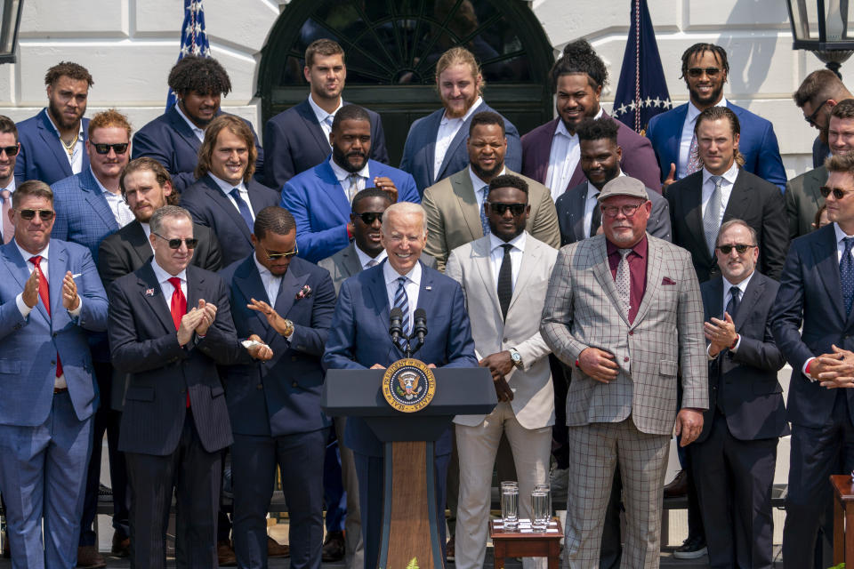 President Joe Biden, surrounded by members of the Tampa Bay Buccaneers, speaks during a ceremony on the South Lawn of the White House in Washington, Tuesday, July 20, 2021, where the president honored the Super Bowl Champion Tampa Bay Buccaneers for their Super Bowl LV victory. Tampa Bay Buccaneers Quarterback Tom Brady at right. (AP Photo/Andrew Harnik)