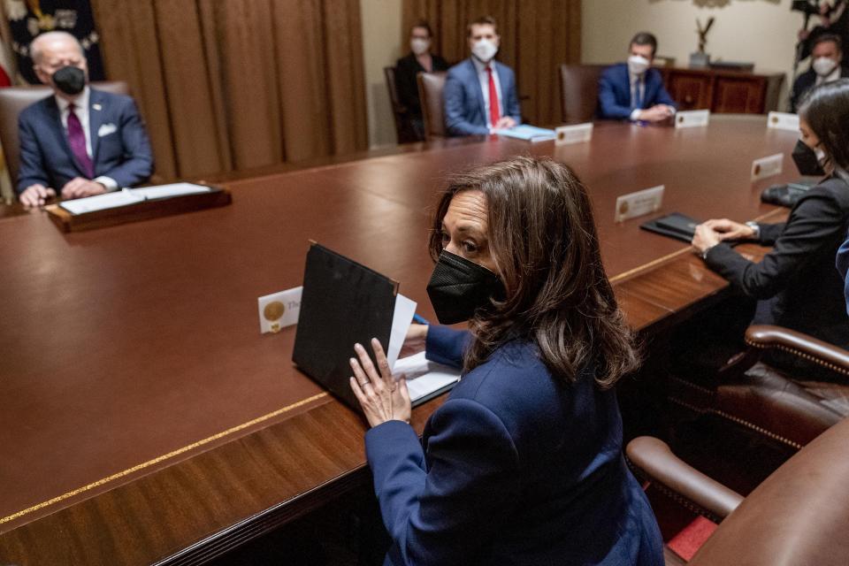 President Joe Biden, left, and Vice President Kamala Harris, center, attend a meeting with members of the Infrastructure Implementation Task Force to discuss the Bipartisan Infrastructure Law, in the Cabinet Room at the White House in Washington, Thursday, Jan. 20, 2022. (AP Photo/Andrew Harnik)