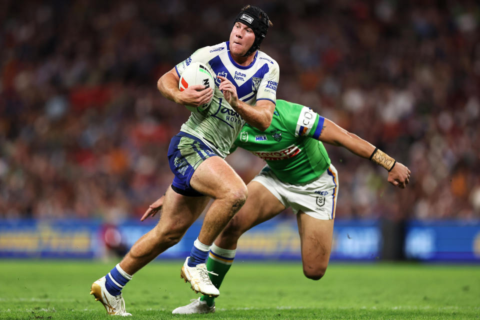 BRISBANE, AUSTRALIA - MAY 17: Matt Burton of the Bulldogs runs the ball during the round 11 NRL match between Canberra Raiders and Canterbury Bulldogs at Suncorp Stadium, on May 17, 2024, in Brisbane, Australia. (Photo by Hannah Peters/Getty Images)