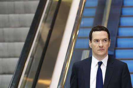 Britain's Chancellor George Osborne walks back to his hotel after radio and television interviews on the second day of the Conservative Party Conference in Birmingham central England September 29, 2014. REUTERS/Luke MacGregor