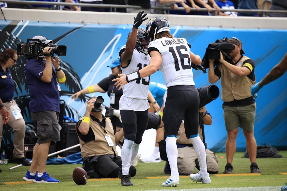 Jacksonville Jaguars wide receiver Christian Kirk (13) scores a touchdown and quarterback Trevor Lawrence (16) celebrates with him during the third quarter Sunday, Sept. 18, 2022 at TIAA Bank Field in Jacksonville. The Jacksonville Jaguars blanked the Indianapolis Colts 24-0. [Corey Perrine/Florida Times-Union]