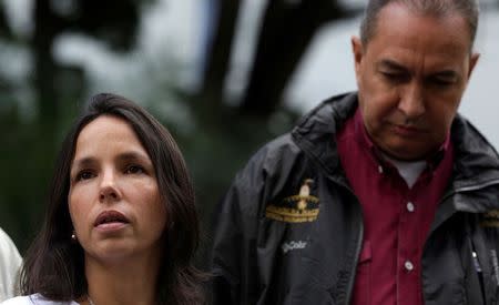 Oriette Schadendorf Capriles, stepdaughter of opposition leader Antonio Ledezma, is accompanied by lawmaker Richard Blanco as she talks to reporters outside their home in Caracas, Venezuela August 4, 2017. REUTERS/Marco Bello