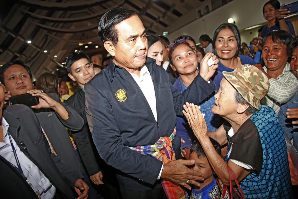 Prime Minister Prayuth Chan-ocha and candidate for the same position, greets local supporters as he attends a government-sponsored event in Nakhon Ratchasima, Thailand, Wednesday, March 13, 2019. Prayuth has been nominated by a pro-army political party to become prime minister again after the March 24 general election. (AP Photo/Sakchai Lalit)