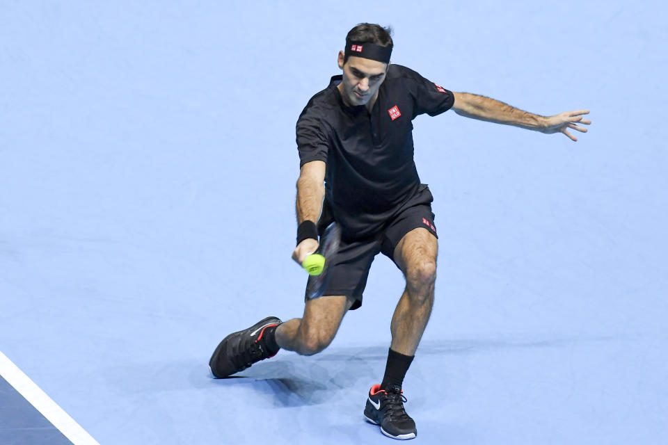Roger Federer of Switzerland returns to Novak Djokovic of Serbia during their ATP World Tour Finals singles tennis match at the O2 Arena in London, Thursday, Nov. 14, 2019. (AP Photo/Alberto Pezzali)