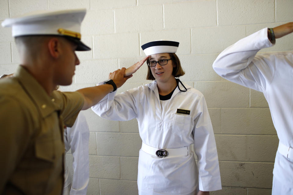 U.S. Marine Corps Second Lieutenant Joseph Cantu, left, adjusts an incoming plebe's salute during Induction Day at the U.S. Naval Academy, Thursday, June 27, 2019, in Annapolis, Md. Members of the class of 2023 reported to the Academy Thursday and received medical examinations, uniforms, haircuts and instructions on how to salute. (AP Photo/Patrick Semansky)