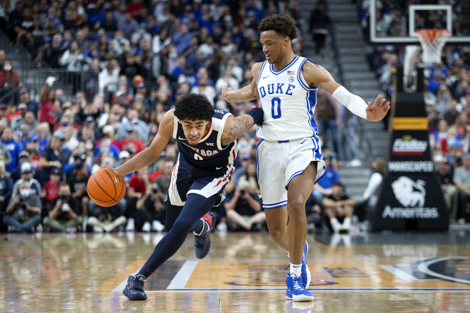 Gonzaga guard Julian Strawther, left, brings the ball up next to Duke forward Wendell Moore Jr. (0) during the first half of an NCAA college basketball game Friday, Nov. 26, 2021, in Las Vegas. (AP Photo/Ellen Schmidt)