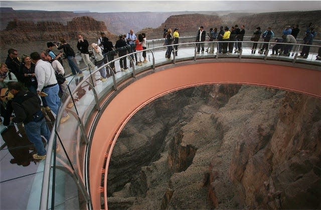 Visitors step onto the Grand Canyon Skywalk on opening day.