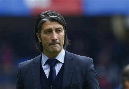 FC Basel's coach Murat Yakin leaves the pitch after the first half of their Swiss Cup final soccer match against FC Zurich in the Stade de Suisse stadium in Bern April 21, 2014. REUTERS/Ruben Sprich