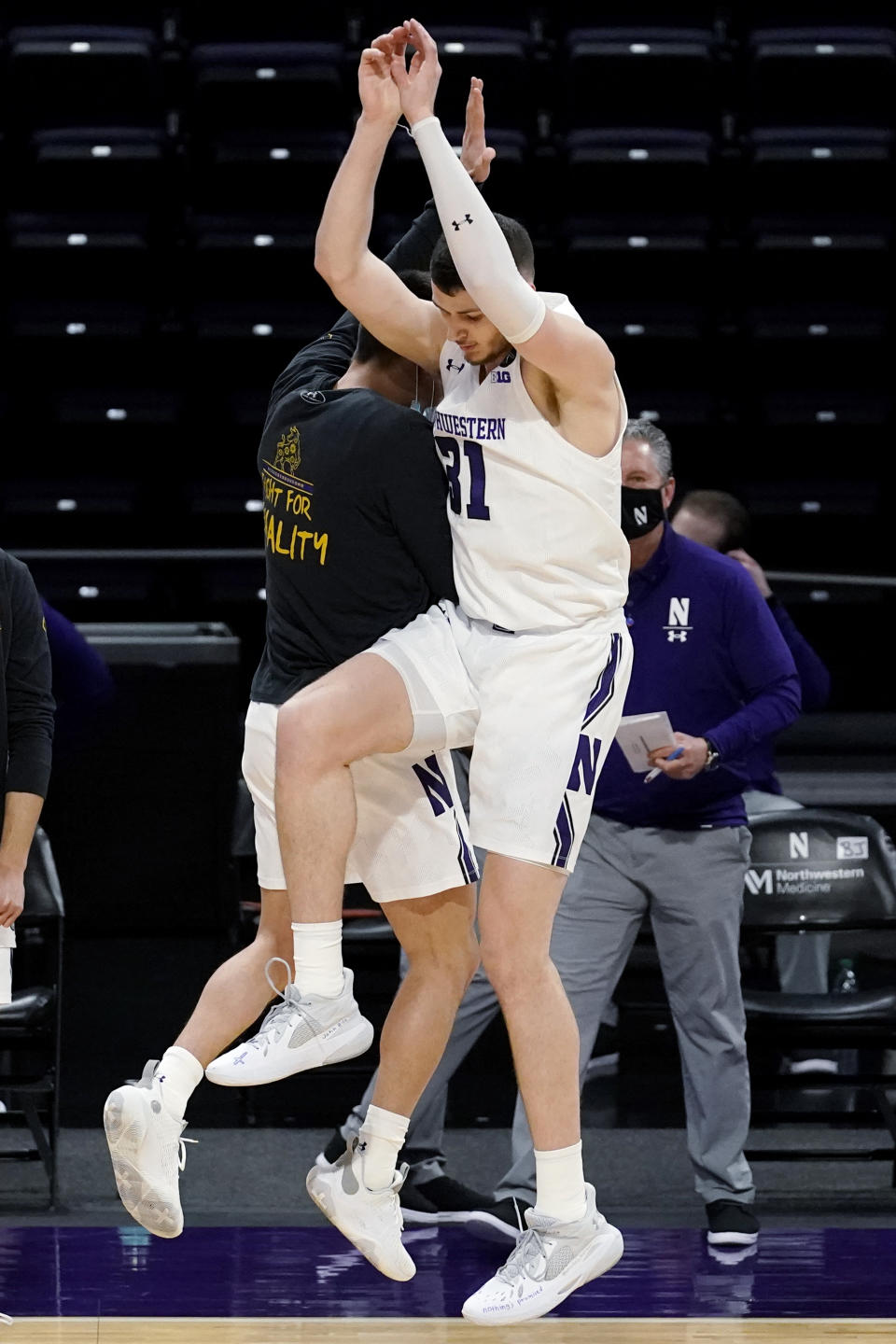 Northwestern forward Robbie Beran, right, celebrates with guard Eric Zalewski after making a 3-point basket against Nebraska during the first half of an NCAA college basketball game in Evanston, Ill., Sunday, March 7, 2021. (AP Photo/Nam Y. Huh)