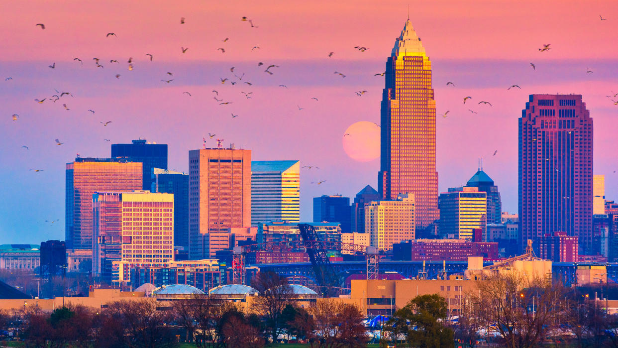 The December supermoon rises above Cleveland Ohio next to the city tallest building.