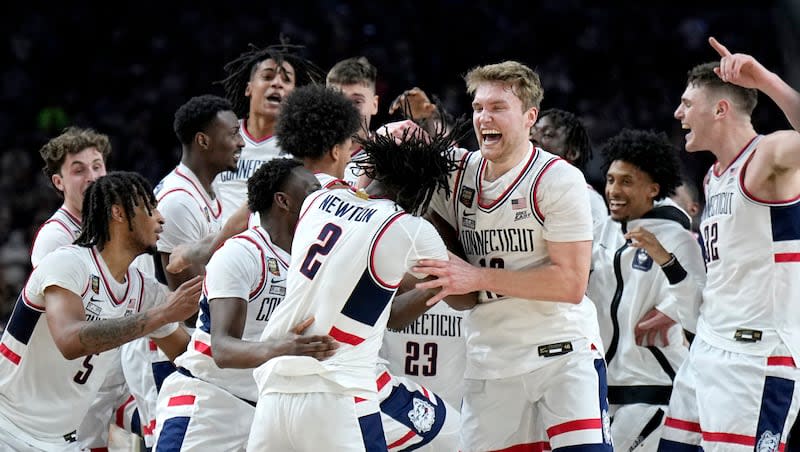 UConn players celebrate as time expires during the second half of the NCAA college Final Four championship basketball game against Purdue, Monday, April 8, 2024, in Glendale, Ariz.