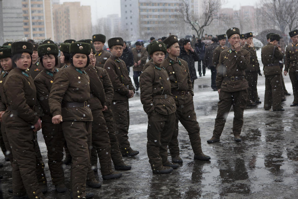 North Korea threatens "hundredfold and thousandfold retaliation" against South Korean troops who had captured or killed armed North Korean agents who had used a submarine to sneak into the South.<br><br>  <em>Caption: North Korean soldiers gather along a Pyongyang street during heavy snowfall on Sunday, Feb. 17, 2013. (AP Photo/David Guttenfelder)</em>