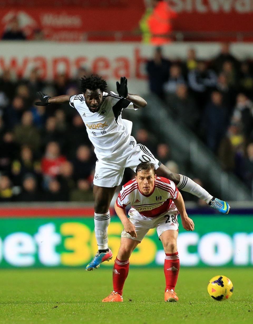Fulham's Scott Parker, below, and Swansea City's Wilfried Bony battle for the ball during their English Premier League soccer match at the Liberty Stadium, Swansea, Wales, Tuesday, Jan. 28, 2014. (AP Photo/Nick Potts, PA Wire) UNITED KINGDOM OUT - NO SALES - NO ARCHIVES