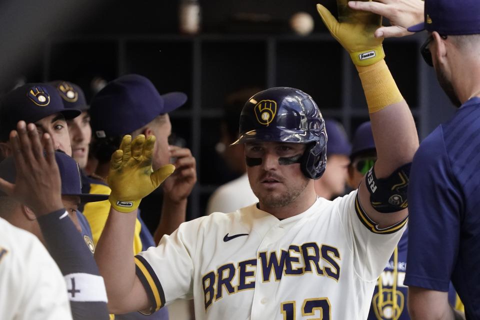 Milwaukee Brewers' Hunter Renfroe is congratulated after hittting a home run during the sixth inning of a baseball game against the Philadelphia Phillies Thursday, June 9, 2022, in Milwaukee. (AP Photo/Morry Gash)