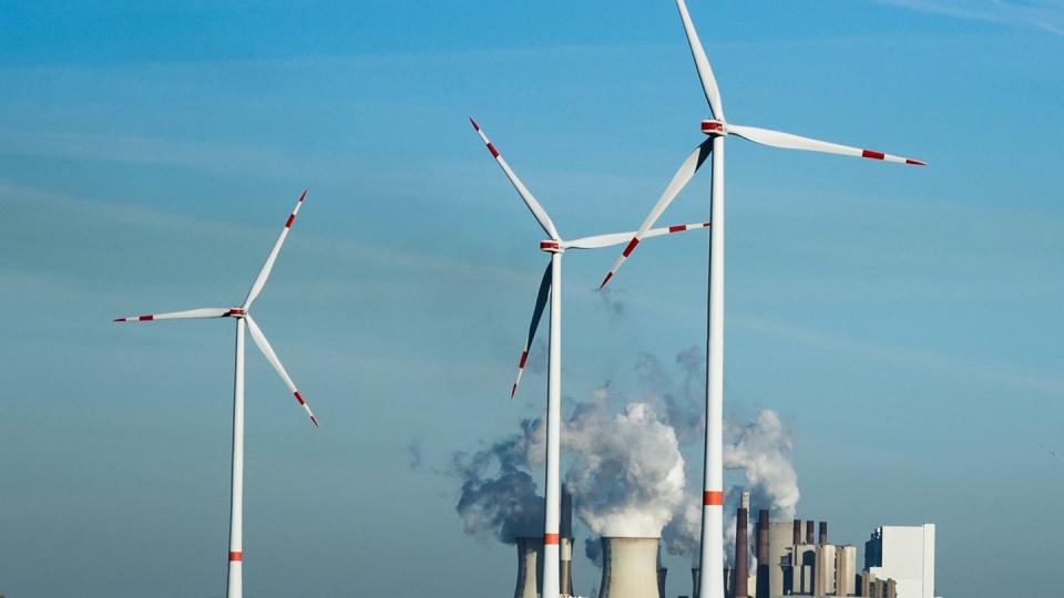 Windräder stehen vor dem Braunkohlekraftwerk Neurath. - Im Klimaschutz-Index mehrerer Organisationen liegt Deutschland noch hinter Staaten wie Indien oder Brasilien.