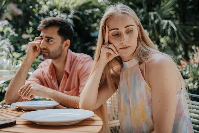 A couple at a table but not looking at one another