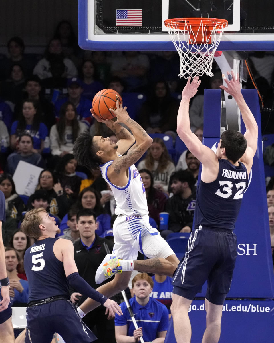 DePaul's Caleb Murphy drives to the basket between Xavier's Adam Kunkel (5) and Zach Freemantle during the first half of an NCAA college basketball game Wednesday, Jan. 18, 2023, in Chicago. (AP Photo/Charles Rex Arbogast)