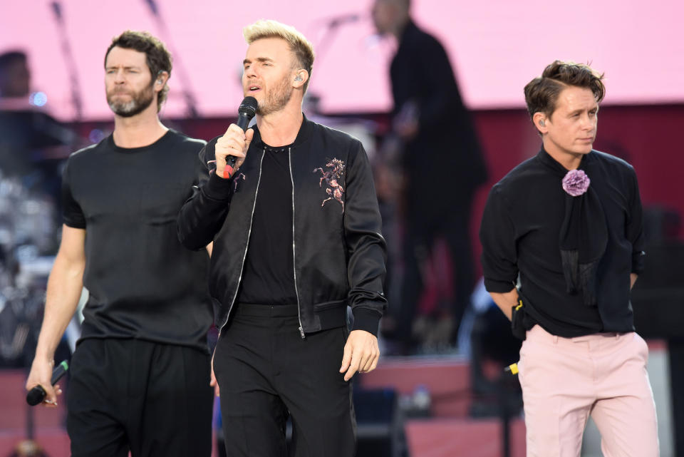 Take That performing on stage. (PA)