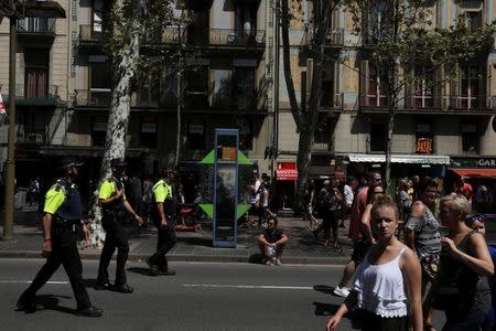 Police officers patrol a day after a van crashed into pedestrians at Las Ramblas in Barcelona, Spain August 18, 2017. REUTERS/Susana Vera