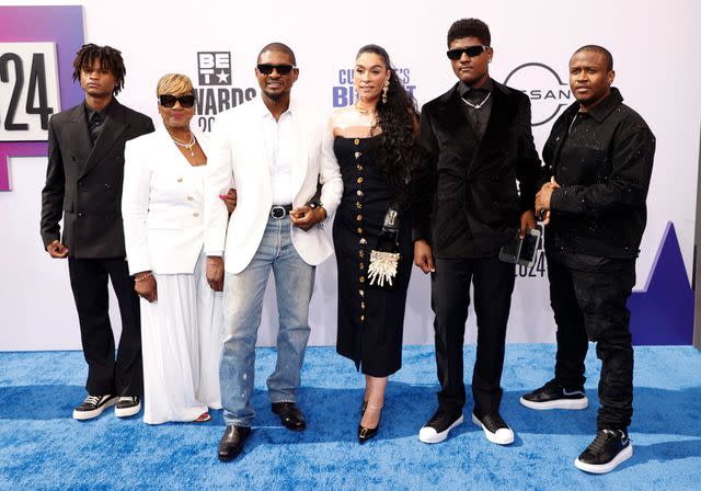 <p>MICHAEL TRAN/AFP via Getty</p> Usher with his wife Jennifer Goicoechea Raymond (C) and family arrive for the 2024 BET Awards in Los Angeles on June 30, 2024