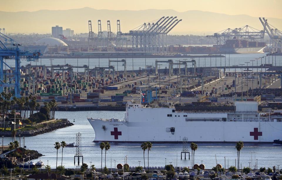 FILE - In this March 27, 2020, file photo, The USNS Mercy enters the Port of Los Angeles in Los Angeles. A train engineer intentionally drove a speeding locomotive off a track at the Port of Los Angeles because he was suspicious about the presence of a Navy hospital ship docked there amid the coronovirus crisis. The locomotive crashed through a series of barriers before coming to rest more than 250 yards from the U.S. Navy Hospital Ship Mercy on Tuesday, March 31, 2020. Nobody was hurt. (AP Photo/Mark J. Terrill, File)