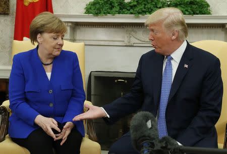 U.S. President Donald Trump greets German Chancellor Angela Merkel in the White House Oval Office in Washington, U.S., April 27, 2018. REUTERS/Kevin Lamarque