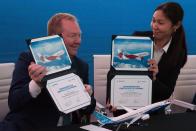 Boeing Commercial Airplanes president and CEO Stanley A. Deal, left, and Air Astana chief planning officer Alma Aliguzhinova pose at a news conference at the Dubai Airshow in Dubai, United Arab Emirates, Tuesday, Nov. 19, 2019. Kazakhstan's national carrier Air Astana announced Tuesday a letter of intent to purchase 30 of Boeing's 737-8 Max jets for its new budget airliner FlyArystan. (AP Photo/Jon Gambrell)