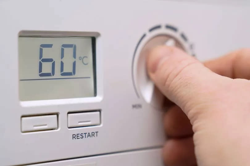 File photo dated 03/02/22/ of a homeowner turning down the temperature of a gas boiler, as Scots living in rural homes face a "tsunami of poverty" amid rising heating costs as Scottish Labour demand clarity on energy discounts for "off-grid" properties.  PA Photo. Issue date: Sunday May 29, 2022. Chancellor Rishi Sunak announced a package of measures to help with the cost-of-living crisis, including a £400 energy bill discount in October for every household in the UK. But Scottish Labour have warned that people living in off-grid properties received little clarification over whether they are eligible for the Energy Bills Support Grant. See PA story SCOTLAND Heating. Photo credit should read: Andrew Matthews/PA Wire