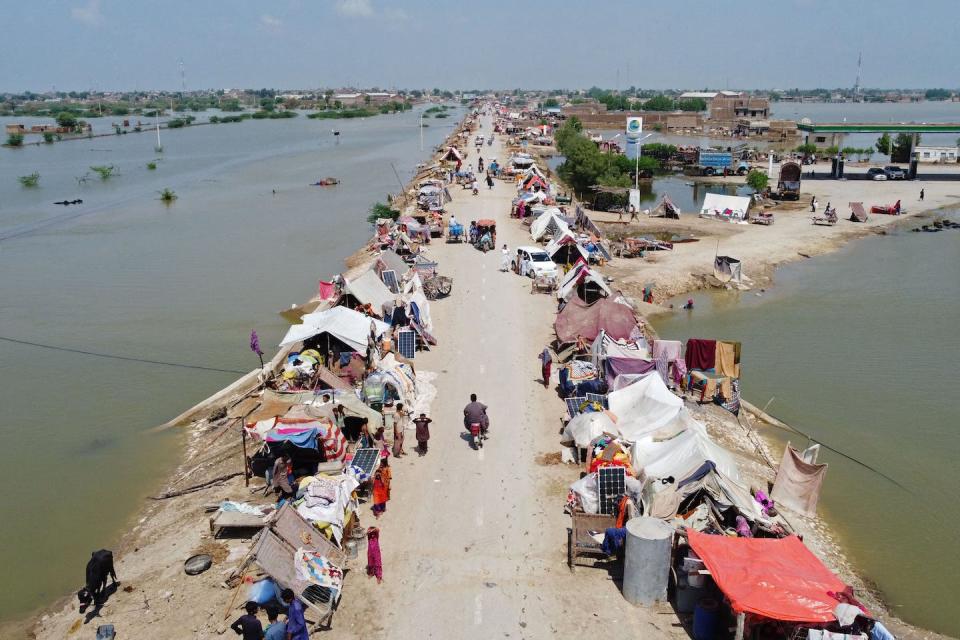 Extensive flooding from extreme rain destroyed homes and livelihoods across Pakistan in 2022. Residents set up tents along a stretch of dry land. <a href="https://www.gettyimages.com/detail/news-photo/this-aerial-photograph-taken-on-august-31-2022-shows-flood-news-photo/1242835834?adppopup=true" rel="nofollow noopener" target="_blank" data-ylk="slk:Fida Hussain/AFP via Getty Images;elm:context_link;itc:0;sec:content-canvas" class="link ">Fida Hussain/AFP via Getty Images</a>