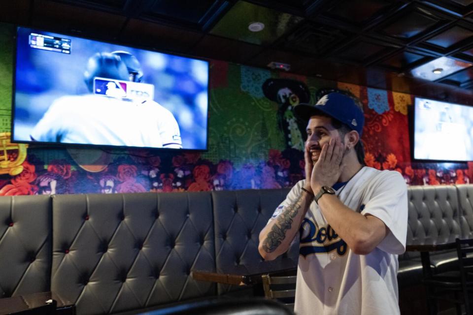 Daniel Mendez holds his hands to his face during a Dodgers game.