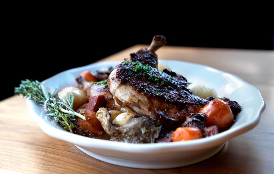 Brick-pressed chicken "au vin" with forest mushrooms, Parisian carrots, bacon lardon and mashed potatoes.