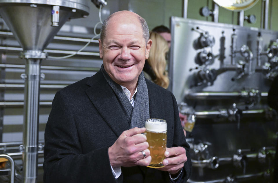 German Chancellor Olaf Scholz holds a glass of beer during his visit to the Gold Ochsen brewery in Ulm, Germany, Monday, Jan. 16, 2023. (Bernd Weissbrod/dpa via AP)