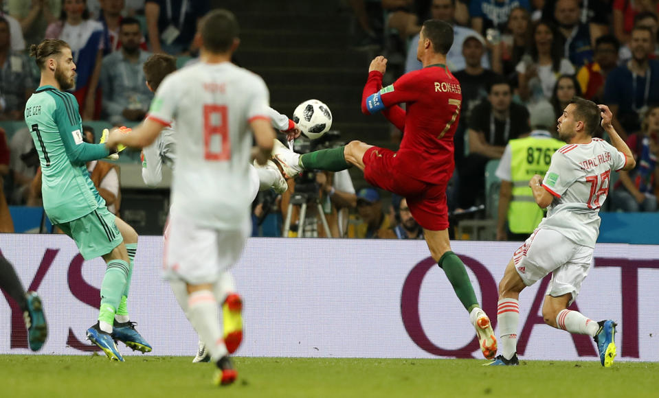 <p>Ronaldo and the Spanish defenders compete for the ball loose ball. (AP) </p>