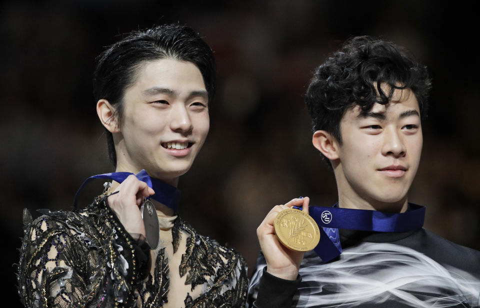 FILE - In this Saturday, March 23, 2019 file photo, Japan's Yuzuru Hanyu and Nathan Chen from the United States display their silver and gold medals respectively during the men's free skating routine during the ISU World Figure Skating Championships at Saitama Super Arena in Saitama, north of Tokyo. As Nathan Chen seeks a third straight World Figure Skating Championships title, something no American has achieved since Scott Hamilton got his fourth in a row in 1984, he has two major challenges in front of him. One is two-time Olympic gold medalist Yuzuru Hanyu of Japan, who Chen calls “the benchmark." The other is idleness in major competitions forced by the coronavirus pandemic. ((AP Photo/Andy Wong, File)