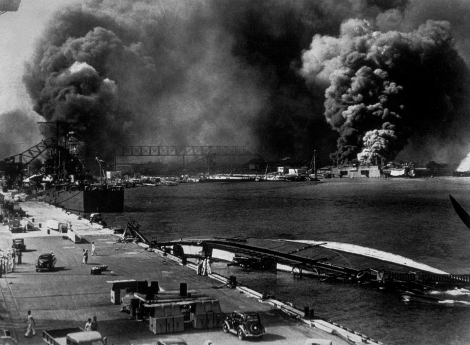 A general view of Pearl Harbour after it had been attacked by the Japanese on Dec. 7, 1941. Smoke pours from USS Shaw (right center) whilst the minelayer USS Oglana lies capsized in the foreground. (Keystone/Hulton Archive/Getty Images/TNS)