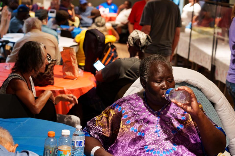 Joyce Obiru drinks water as she sits inside on July 16, 2023 in Phoenix, AZ.