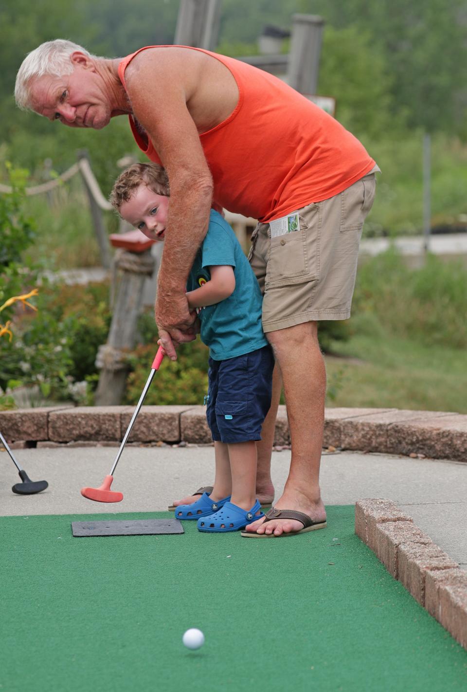 Tom Sossaman, of Rochester, plays mini golf with his 3-year-old grandson Tanner Lierman, of Germantown at Swing Time Mini Golf in Germantown on Wednesday, July 28, 2021.  - Photo by Mike De Sisti / Milwaukee Journal 