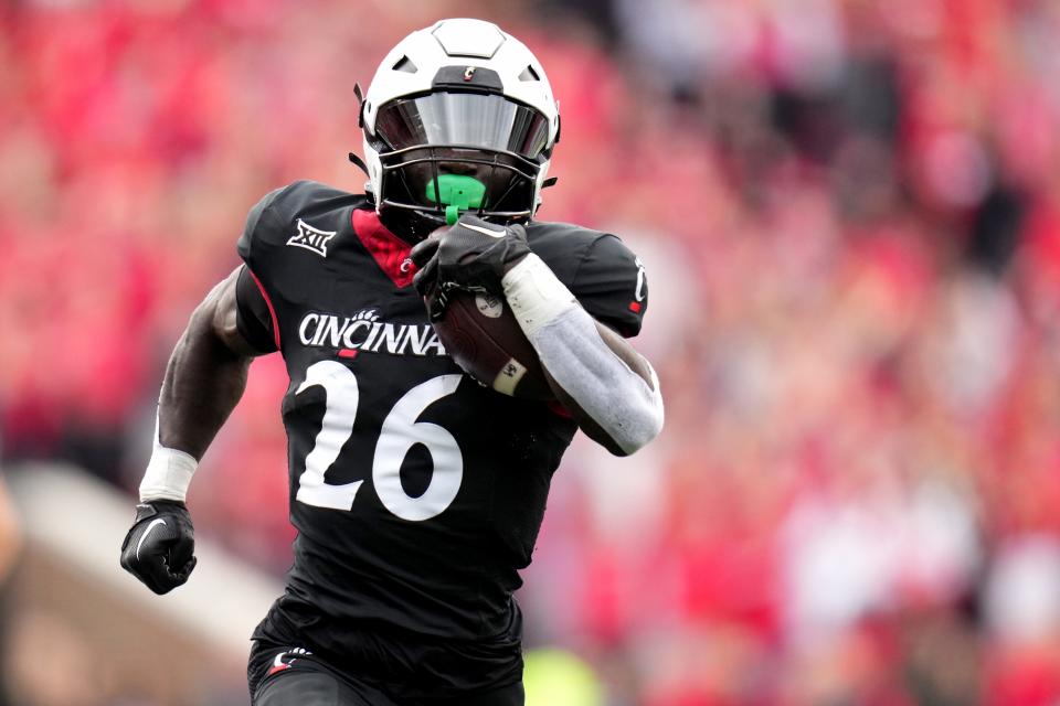 Cincinnati Bearcats running back Myles Montgomery (26) breaks free from Baylor Bears cornerback Chateau Reed (21) on a touchdown run in the second quarter during a college football game between the Baylor Bears and the Cincinnati Bearcats, Saturday, Oct. 21, 2023, at Nippert Stadium in Cincinnati.
