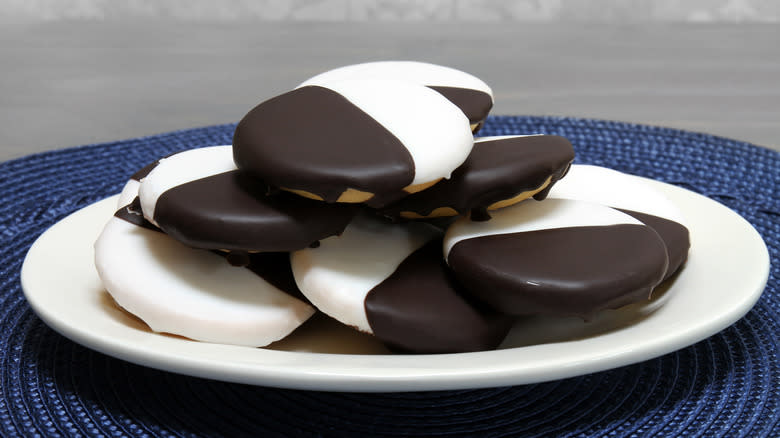 Stacked black-and-white cookies on plate