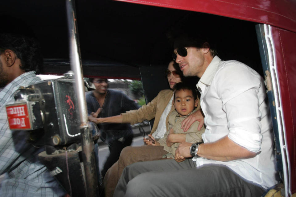 Brad Pitt, Angelina Jolie and son Maddox take an autorickshaw ride in Pune, India, in 2006.<p>Hindustan Times/Getty Images</p>