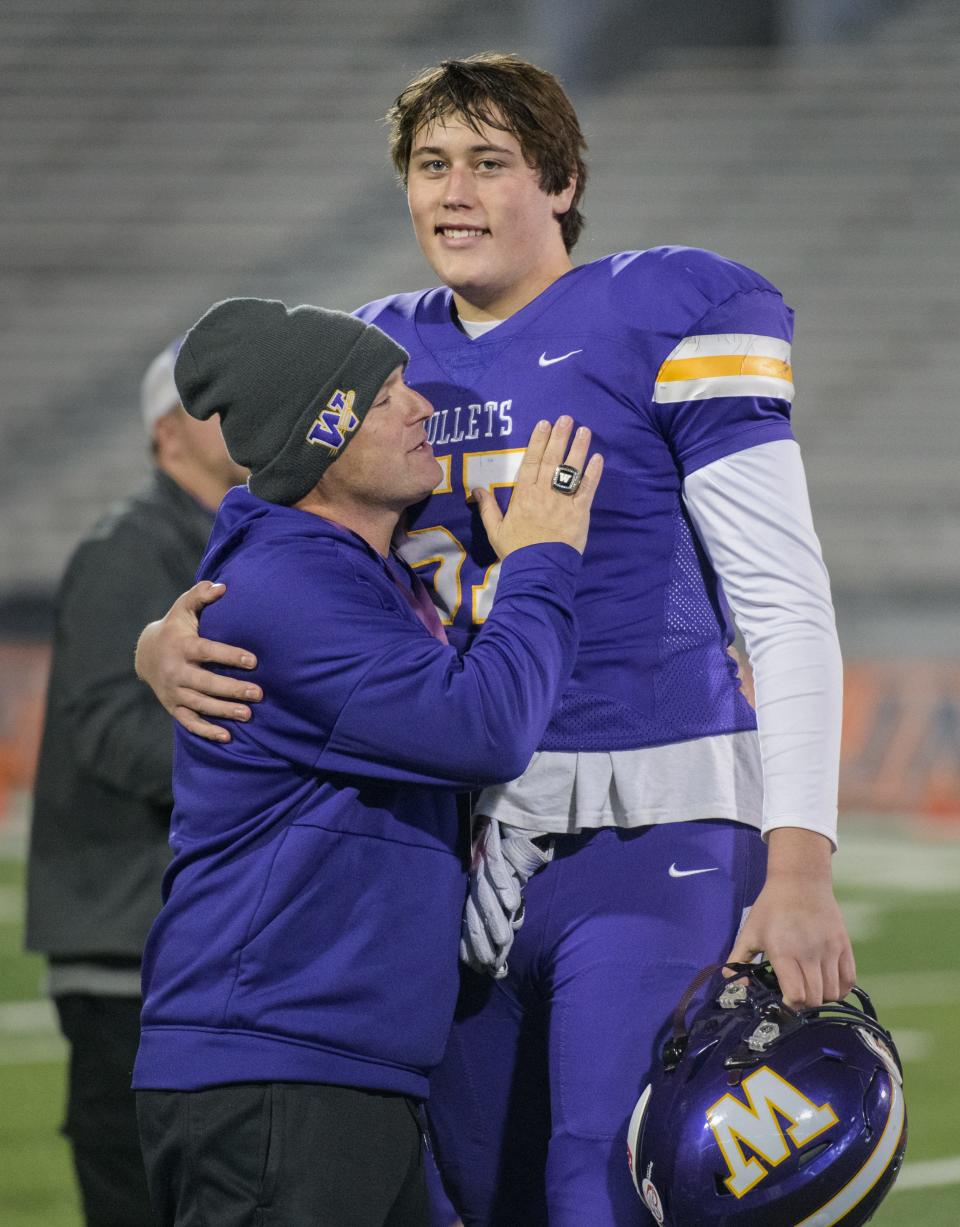 Williamsville head coach Aaron Kunz gives senior lineman Jacob Finley a hug after the Bullets' 48-17 loss to IC Catholic in the Class 3A football state title game Friday, Nov. 25, 2022 in Champaign.