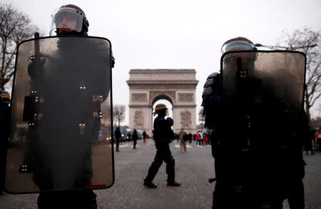 Riot police officers stand guard during a demonstration by the "yellow vests" movement on the Champs Elysees near the Arc de Triomphe in Paris, France, December 29, 2018. REUTERS/Christian Hartmann