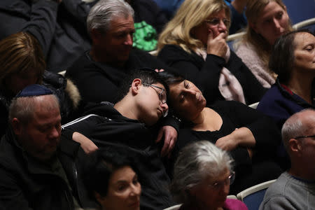 Mourners attend a memorial service at the Sailors and Soldiers Memorial Hall of the University of Pittsburgh, a day after 11 worshippers were shot dead at a Jewish synagogue in Pittsburgh, Pennsylvania, U.S., October 28, 2018. REUTERS/Cathal McNaughton