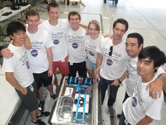 Engineering students with the UCSD Microgravity Team from the University of California, San Diego, stands near their biofuel experiment to test weightless flames ahead of a NASA Microgravity University flight at Ellington Field in Houston. The