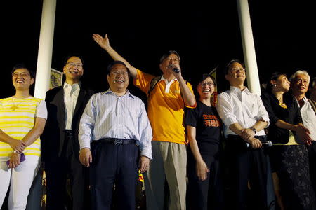 Pro-democracy lawmakers including veteran Albert Ho (3rd L) and Lee Cheuk-yan (4th L) attend a rally with their supporters outside the Legislative Council in Hong Kong, China June 17, 2015. REUTERS/Liau Chung-ren