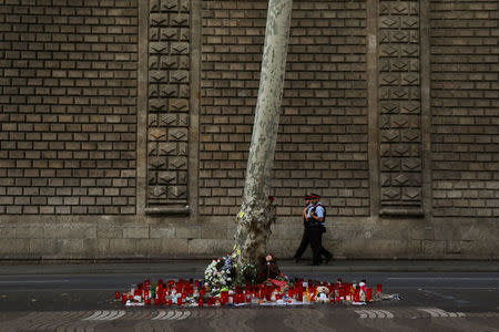 Catalan Mossos d'Esquadra officers patrol near an impromptu memorial where a van crashed into pedestrians at Las Ramblas in Barcelona, Spain, August 20, 2017. REUTERS/Susana Vera