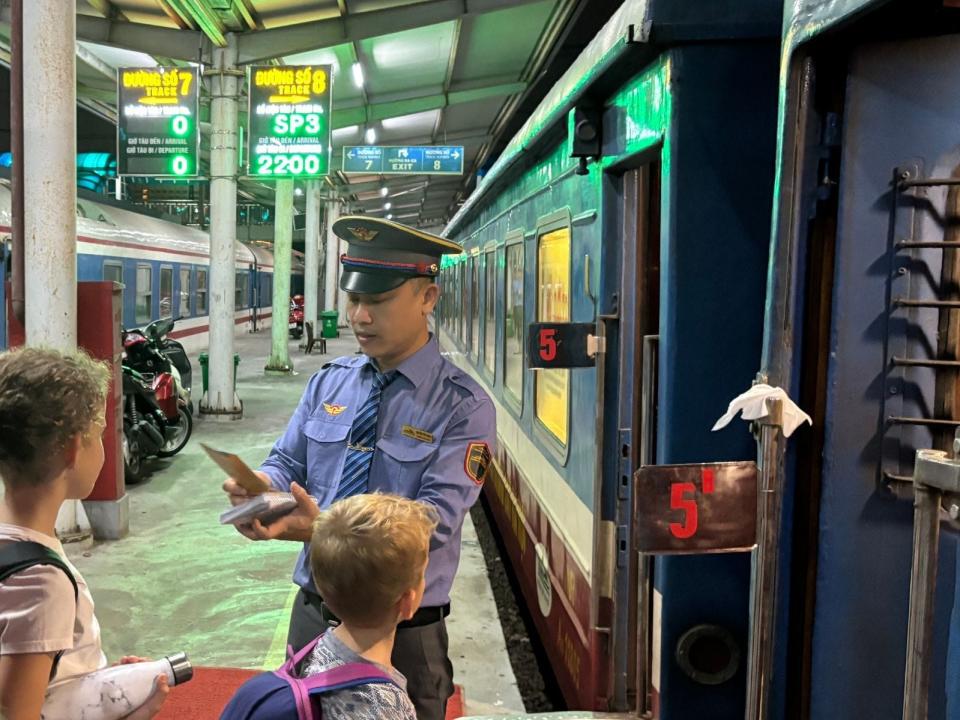 Two kids getting on train in Vietnam