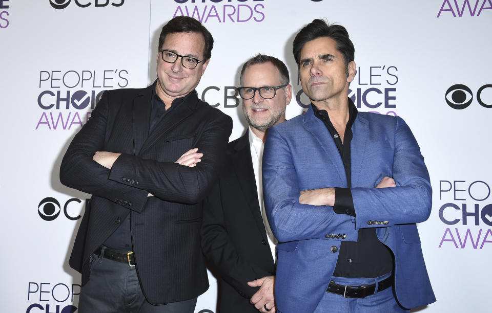 FILE - Bob Saget, from left, Dave Coulier and John Stamos, winners of the award for favorite premium comedy series for "Fuller House," pose in the press room at the People's Choice Awards at the Microsoft Theater on Wednesday, Jan. 18, 2017, in Los Angeles. Saget, a comedian and actor known for his role as a widower raising a trio of daughters in the sitcom “Full House,” has died, according to authorities in Florida, Sunday, Jan. 9, 2022. He was 65. (Photo by Jordan Strauss/Invision/AP, File)