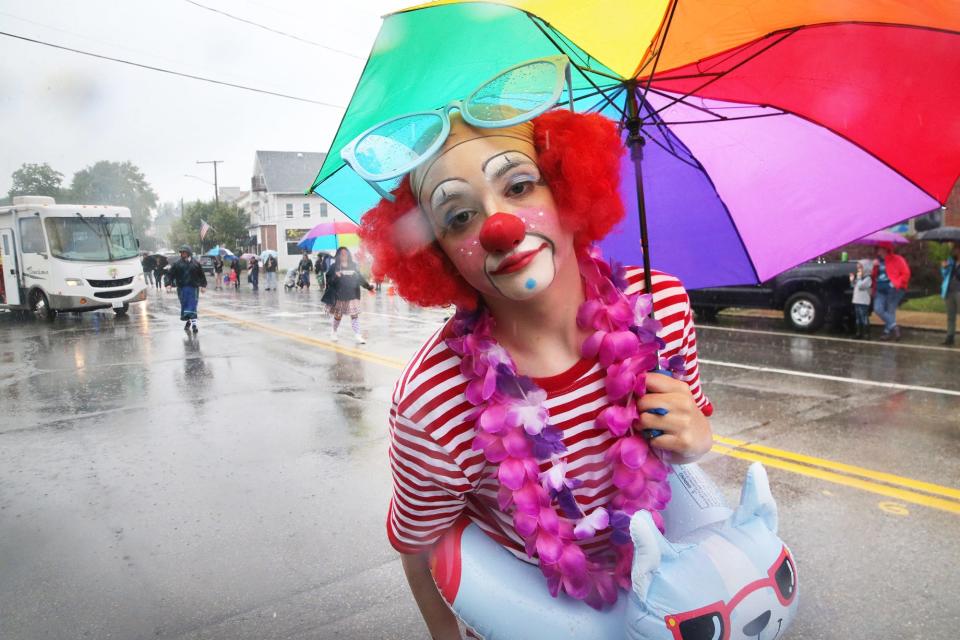 A clown from Clowning for Kidz Foundation gazes into the camera while marching in the 2023 Dover 400th Anniversary Parade on Sunday, July 2.