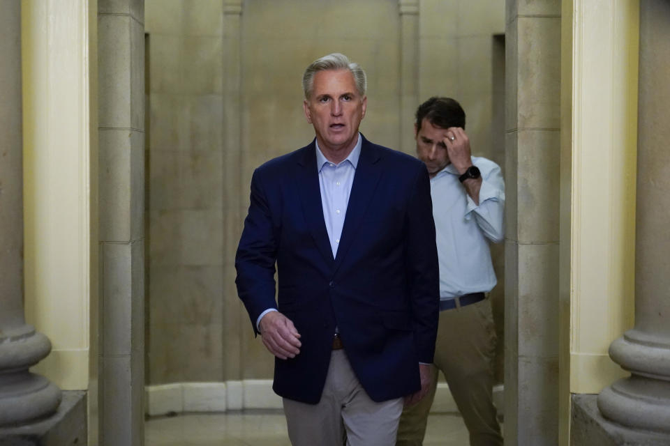 Speaker of the Kevin McCarthy, R- Calif., walks out of his office to speak with members of the press after participating in a phone call on the debt ceiling with President Joe Biden, Sunday, May 21, 2023, on Capitol Hill in Washington. Walking behind McCarthy is Rep. Garret Graves, R-La., McCarthy's top mediator in the debt limit talks. / Credit: Patrick Semansky / AP